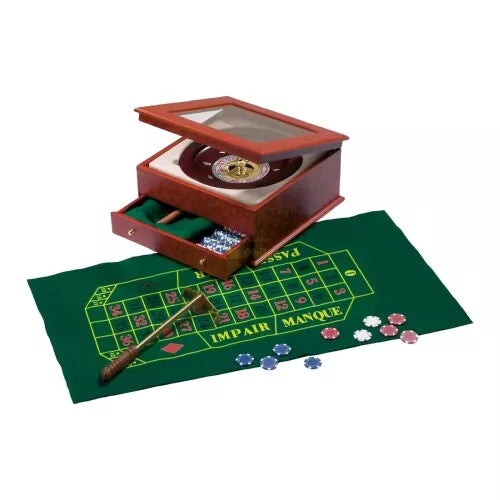 Wooden roulette set with wheel in glass-top box, green felt betting mat, colorful chips, and a brass-tipped rake.
