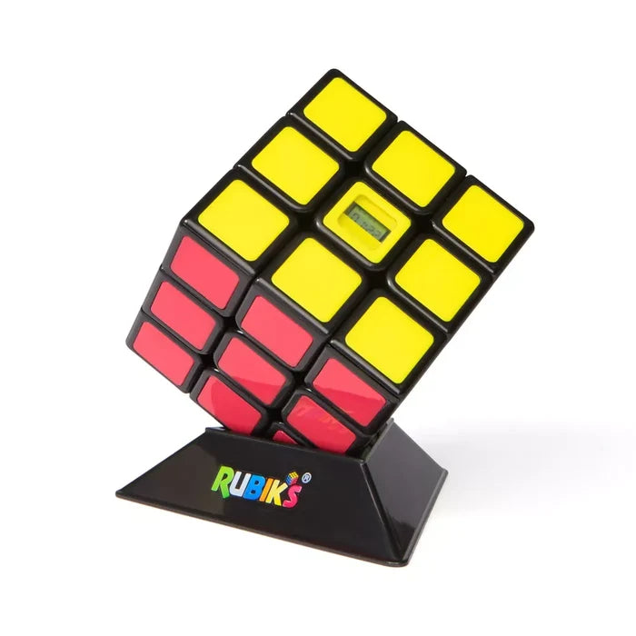 Yellow and red 3x3 cube with a built-in digital timer display, resting on a black Rubik's branded pedestal.