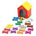 Red and yellow toy doghouse with a small plush dog and 20 colorful bones in ten different pairs of tactile textures.