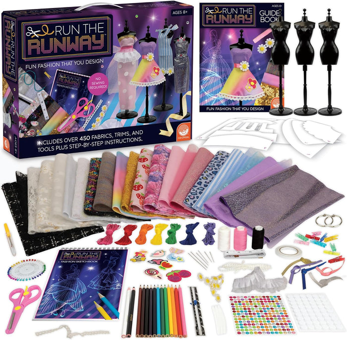 Fashion design kit with colorful fabrics, 3 mannequins, sketchbook, and tools next to a purple and black product box.