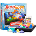 ThinkFun Rush Hour logic game box with colorful plastic car pieces, game tray, and challenge cards.