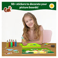 Child creating animal sand art with colorful sand bottles, stickers, and a jungle-themed picture board.