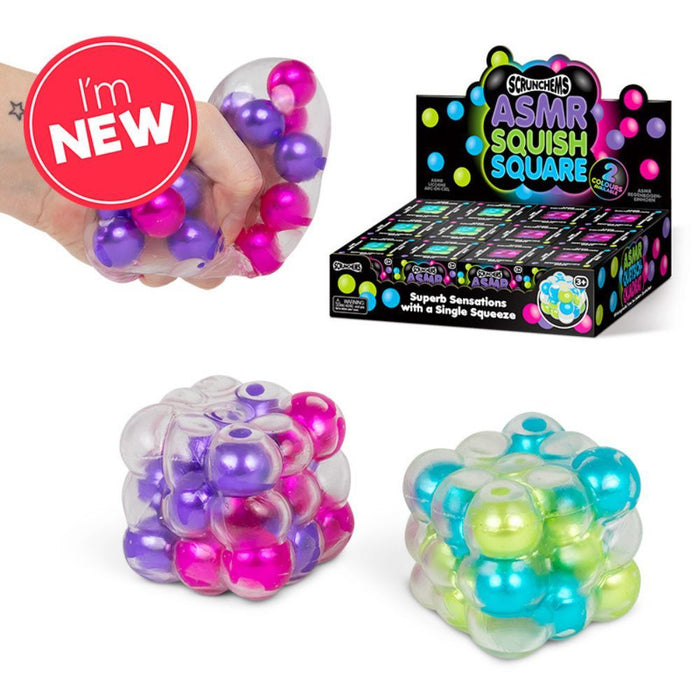 Clear squishy cubes with pink, purple, blue, and green metallic beads, plus retail packaging and a hand squeezing one.