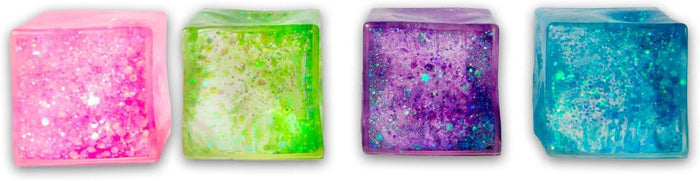 Four translucent squishy cubes in pink, lime green, purple, and blue, each filled with shimmering glitter.