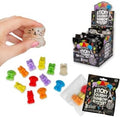 Small colorful bear and cat squishies shown with retail display box and black mystery blind pack packaging.