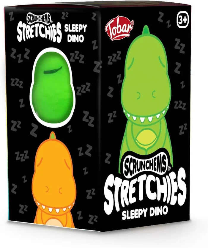 Black toy box featuring green and orange sleepy dinosaurs and a circular window showing a squishy green toy.