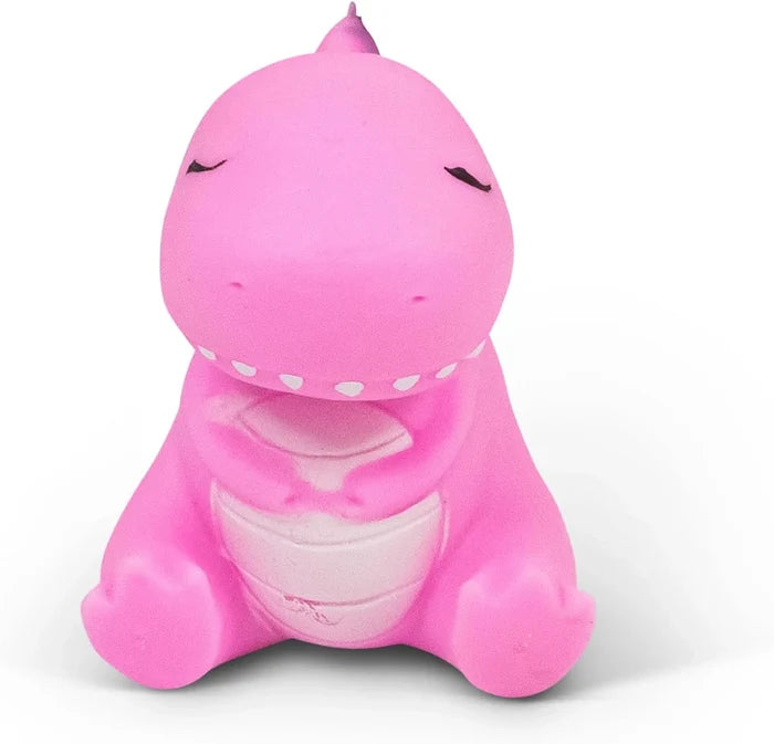 Pink squishy dinosaur toy sitting with closed eyes, a light pink belly, and small white teeth.