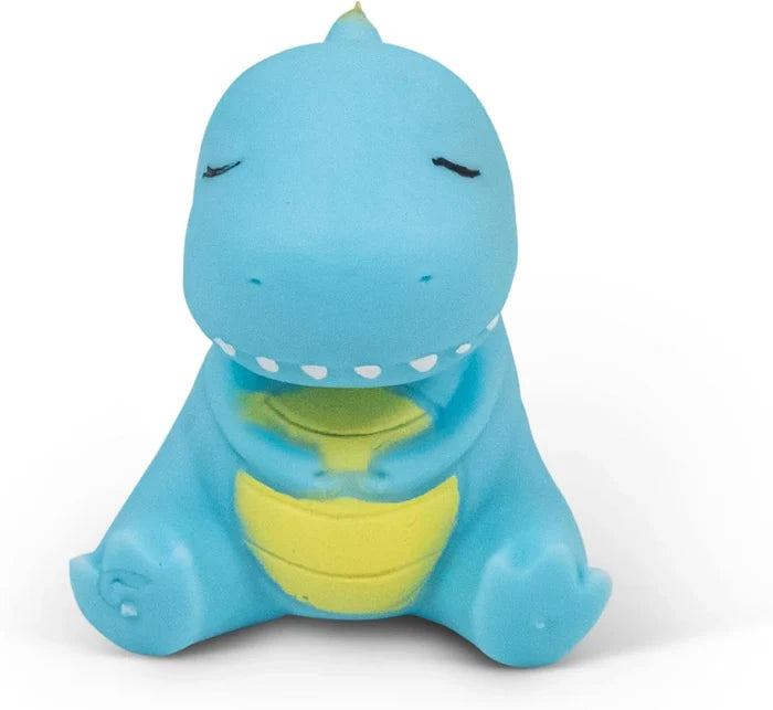 Small blue rubbery dinosaur toy sitting with closed eyes, white teeth, and a yellow ridged belly.