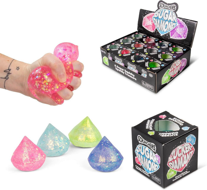 Hand squeezing a pink glittery squishy diamond beside blue and green versions and retail display packaging.