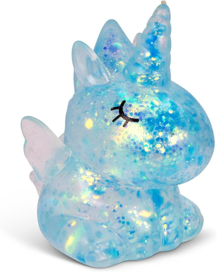 Translucent blue unicorn squishy toy filled with sparkly glitter and iridescent flakes, featuring closed eyelashes.