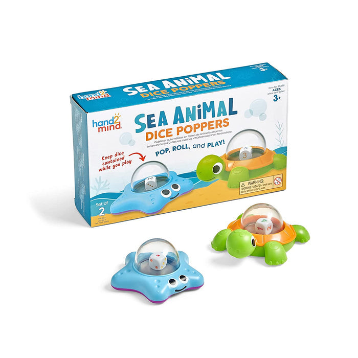Blue starfish and green turtle toys with dice in clear domes, shown in front of their colorful retail box.