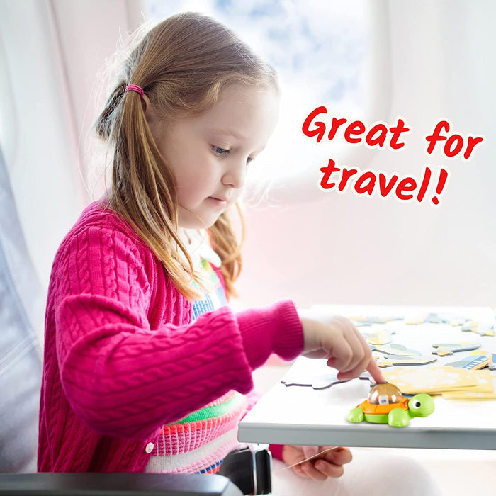 Young girl using a green turtle dice popper on an airplane tray table. Overlaid text says Great for travel!