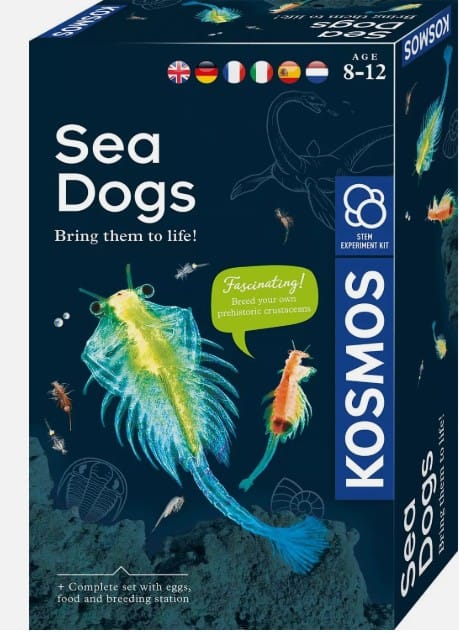 KOSMOS Sea Dogs STEM kit box featuring vibrant neon green and blue brine shrimp swimming in dark blue water.