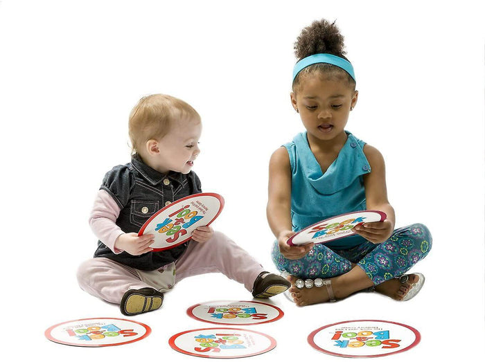 Two children playing with large round cards featuring red borders and colorful Seek-a-Boo! text on a white background.
