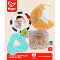 Hape baby toy: black and white ring, orange plush moon, teal letter A teether, and clear B rattle with colorful beads.