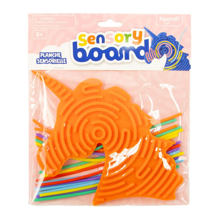 Orange unicorn-shaped sensory board with maze ridges and colorful sticks in clear plastic packaging.