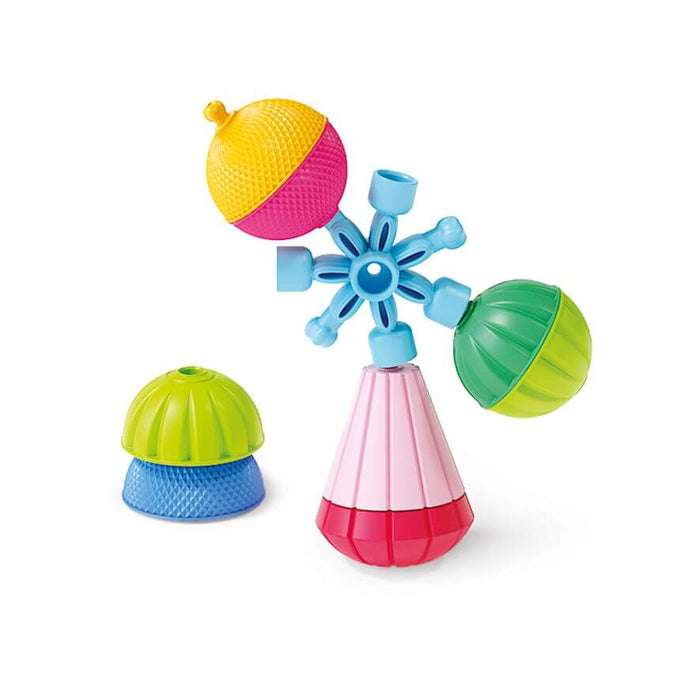 Brightly colored textured toy pieces assembled into a star shape with spheres and a pink conical base.