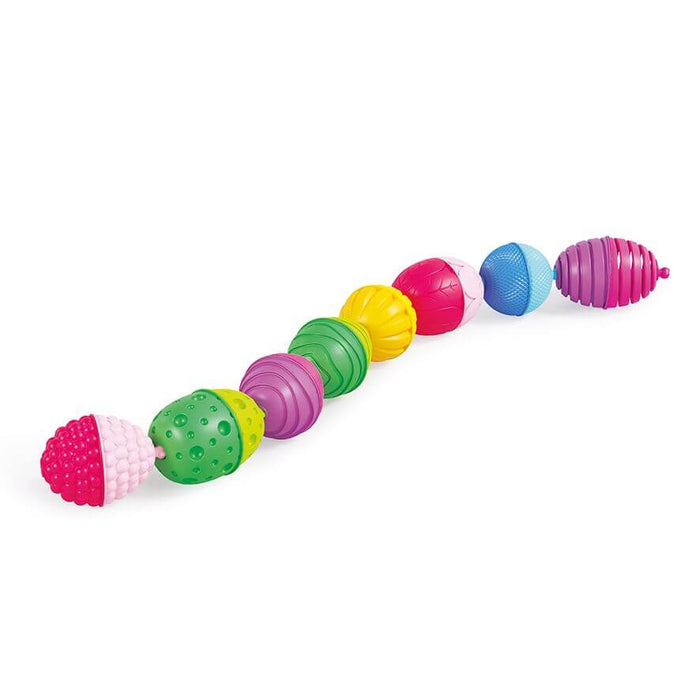 Multi-colored, textured plastic snap beads in a curved line, featuring varied patterns and vibrant hues.
