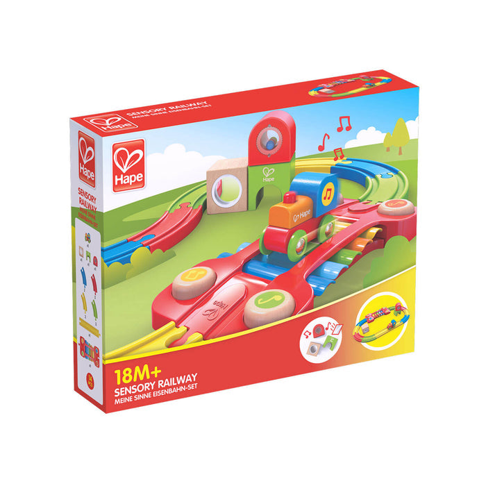 Red box for a colorful toy train set with wooden tracks, a red bridge, and small engine, labeled for ages 18M+.