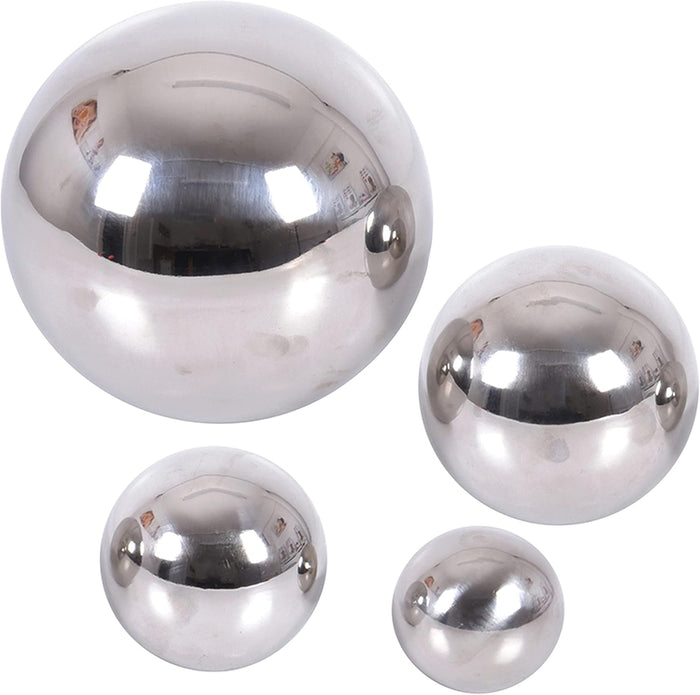 Four shiny silver spheres in varying sizes with highly reflective mirror-like surfaces against a white background.
