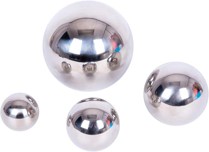 Four polished silver spheres of different sizes with reflective mirror finishes on a plain white background.