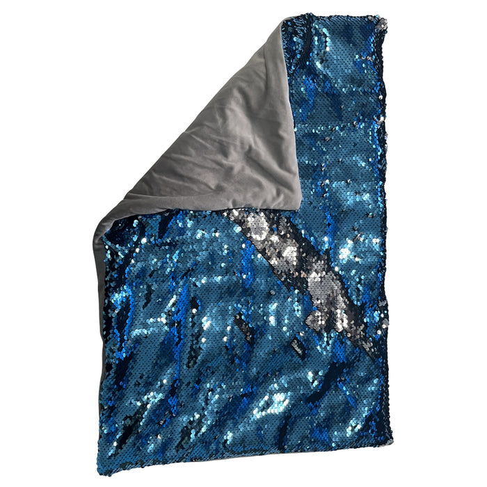 Rectangular blue and silver reversible sequin lap pad with a grey fabric underside visible at one folded corner.