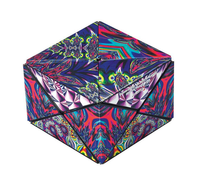 Geometric puzzle box in a multi-faceted shape with a vibrant, kaleidoscopic pattern in purple, red, blue, and green.