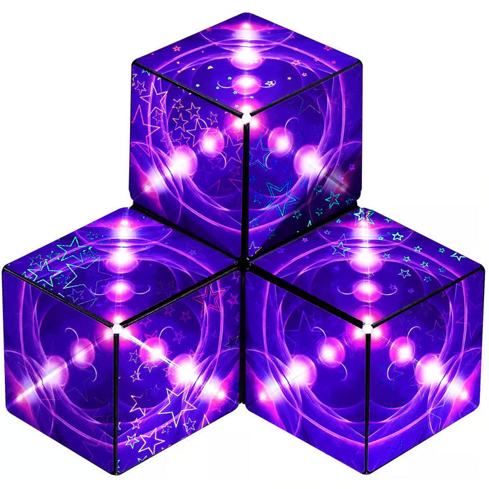 Three magnetic puzzle cubes with a purple cosmos pattern of stars and glowing spheres stacked in a pyramid.