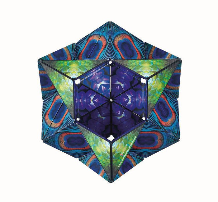 Star-shaped 3D puzzle with peacock feather patterns, green floral accents, and a purple kaleidoscopic center.