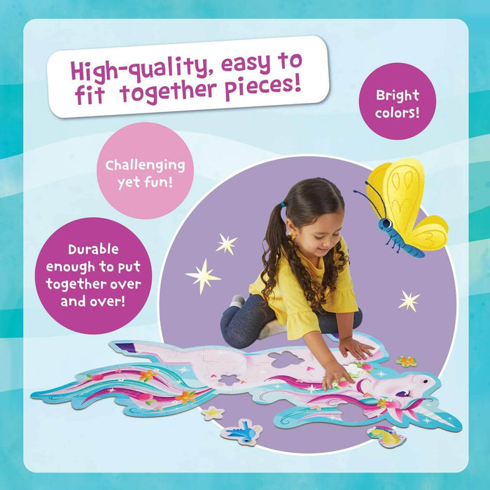 A girl assembling a large, unicorn-shaped floor puzzle with bright pastel colors and shimmery star accents.