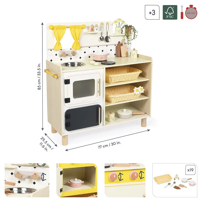 Wooden toy play kitchen in natural wood, white and yellow with a sink, oven, shelving, and 19 accessories.