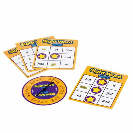 Four yellow bingo cards with sight words and purple star markers next to a matching circular spinner.