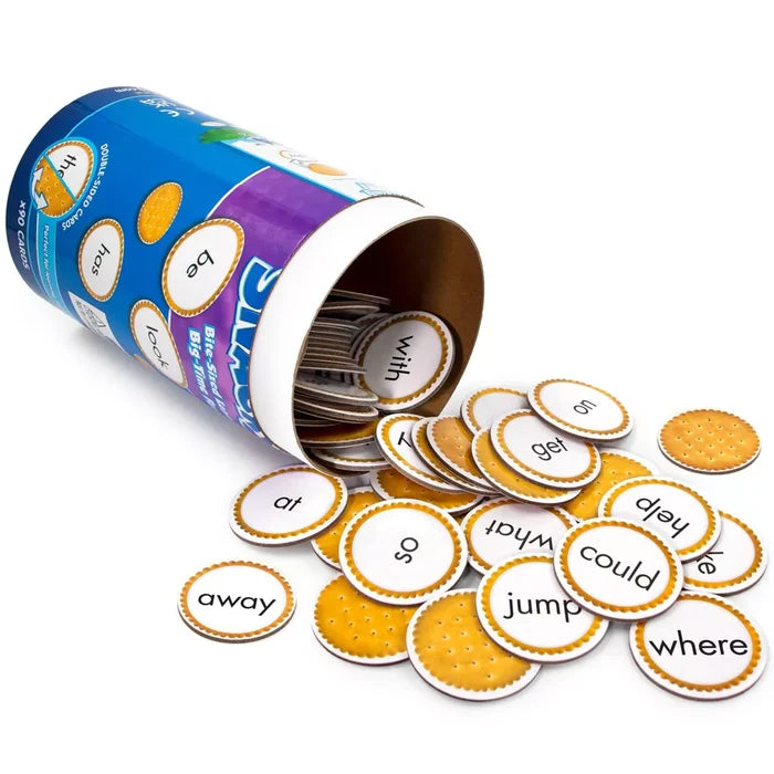 Blue cylindrical canister spilling round cracker-themed cards with sight words like away, jump, and could.