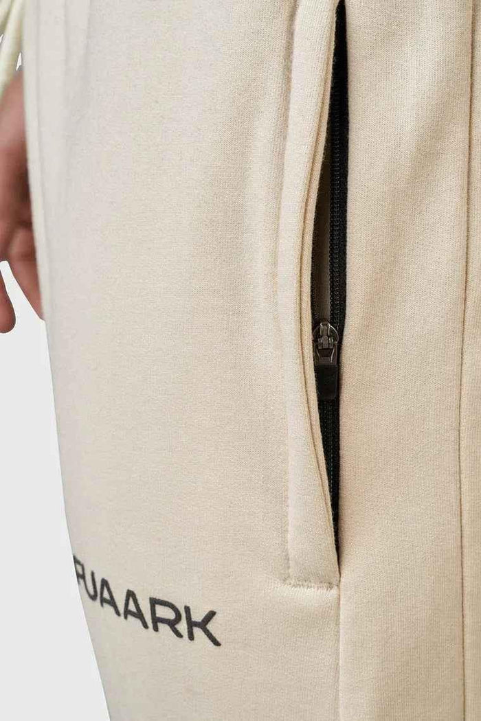 Beige oversized signature joggers from Fuaark Nz with relaxed fit and elastic waistband, casual and comfortable for everyday wear.