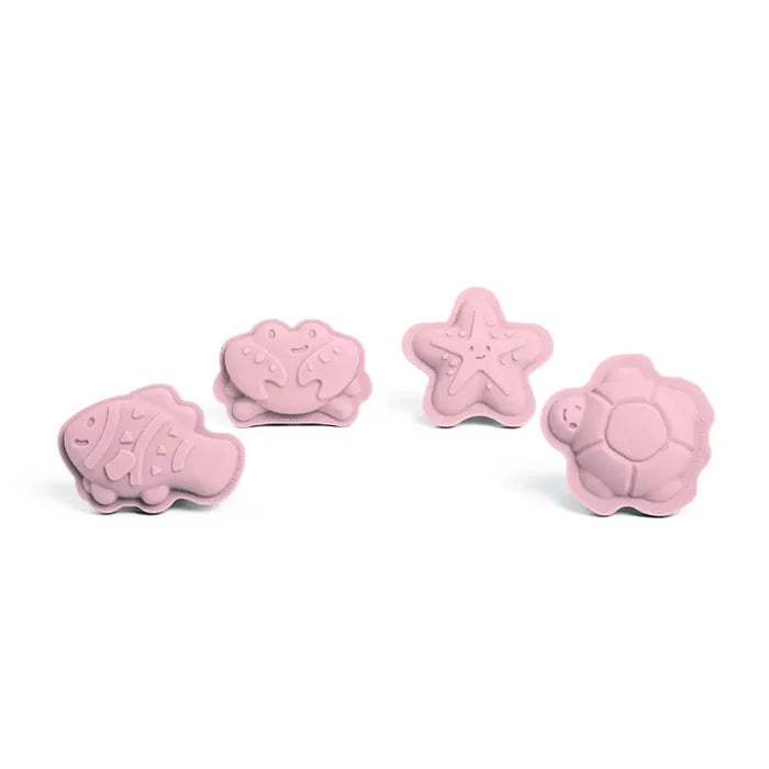 Four pale pink silicone sand moulds in the shapes of a fish, crab, starfish, and sea turtle.