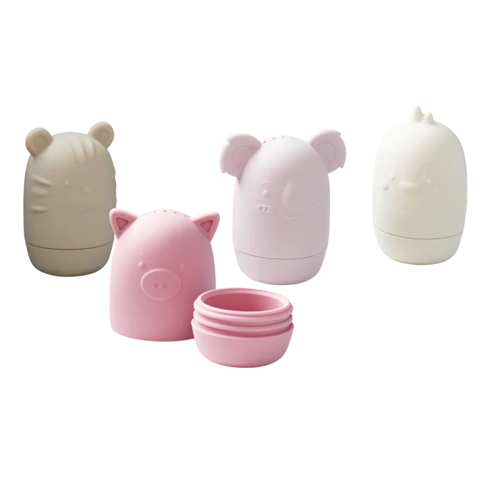 Four pastel silicone animal bath toys. One pink toy is unscrewed into two pieces to show the open base.