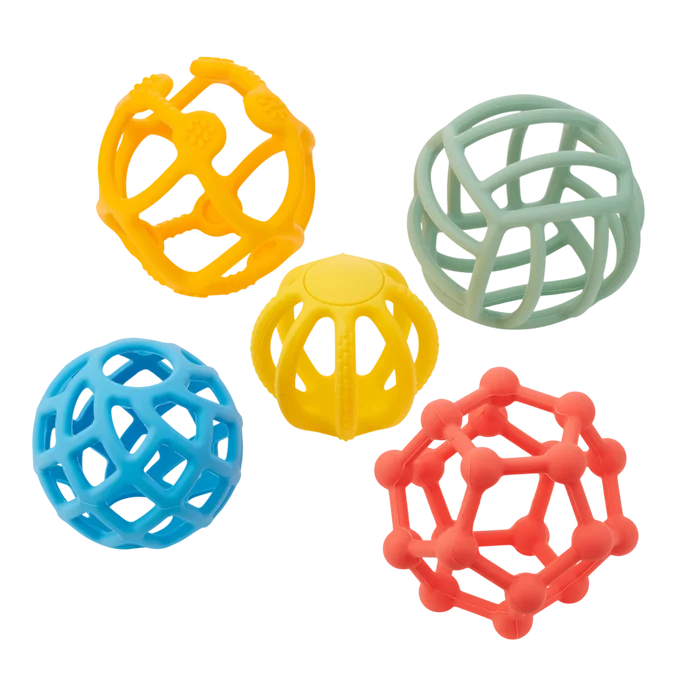Five silicone balls with unique geometric cutout patterns in orange, green, blue, yellow, and coral red.