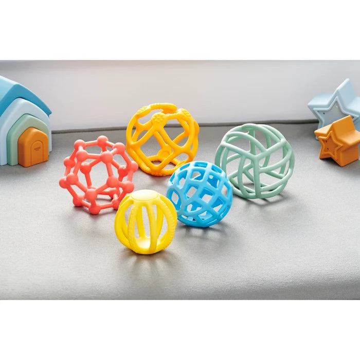 Five flexible silicone balls with unique geometric lattice designs in orange, yellow, blue, and light green.