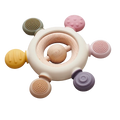 Circular baby teether with a wooden ring center and six textured silicone knobs in muted earth tones.