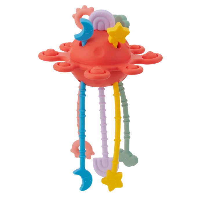 Red saucer-shaped silicone toy with pop-it buttons and colorful textured pull strings ending in star and moon shapes.