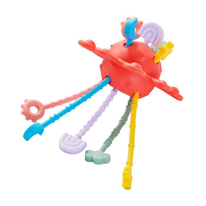 Red spherical sensory toy with colorful, textured silicone pull strings and various shaped ends.