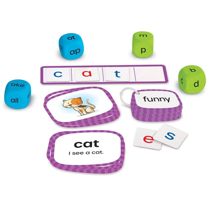 Phonics activity set with letter tiles, green and blue word dice, and colorful cards with pictures and simple sentences.