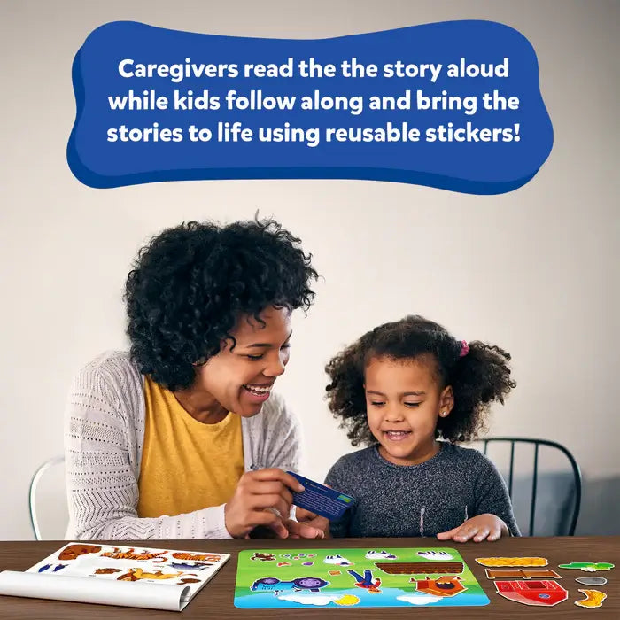 Woman and child use colorful animal stickers on a farm landscape mat and follow along with a story card.