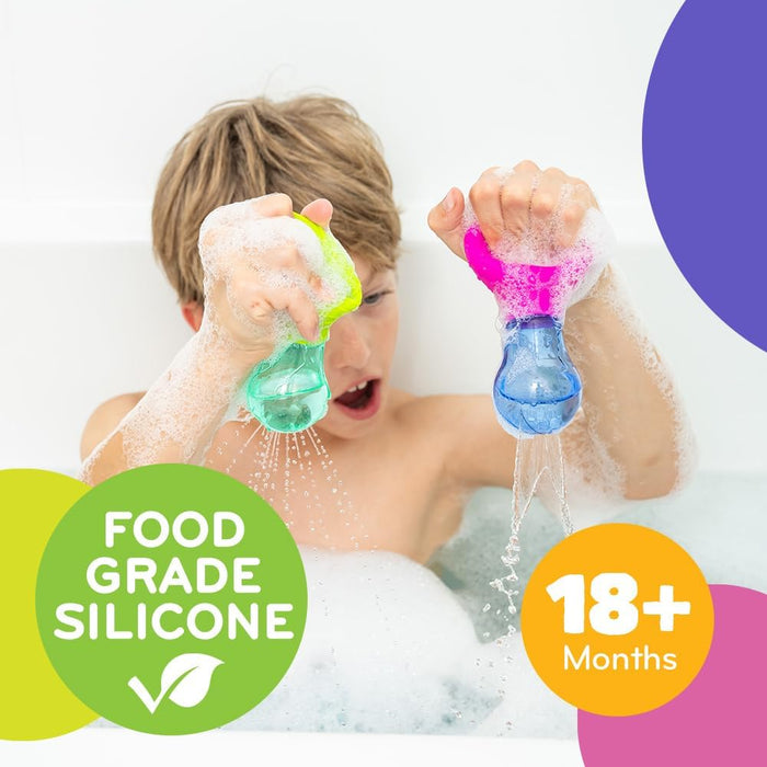 Child in bubble bath squeezing pink and green silicone bulbs that squirt water. Labeled food grade and 18+ months.