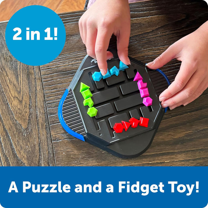 Hands sliding blue, green, pink, and red geometric pieces on a black hexagonal puzzle toy over a wooden table.