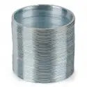 Shiny silver metal spring toy compressed into a tall cylindrical shape with many thin, tightly coiled rings.