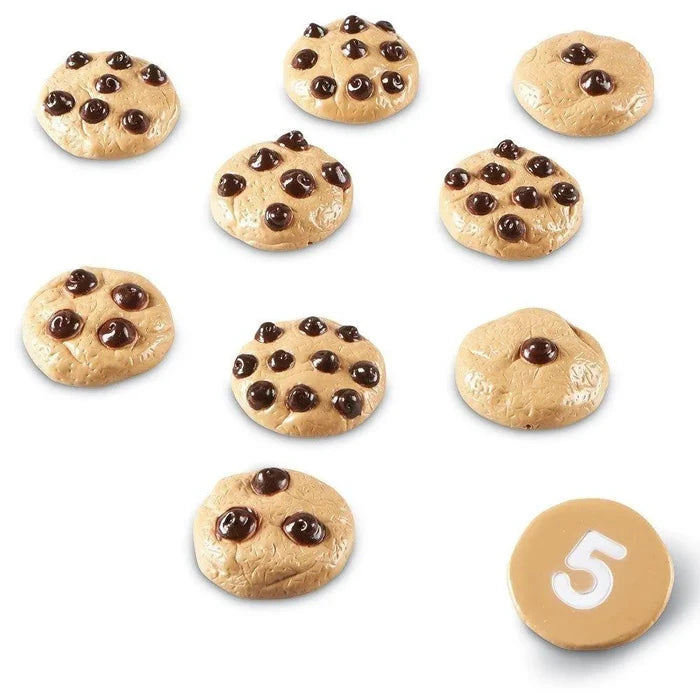 Ten round, tan toy cookies with dark brown chips. One is flipped over showing the white number 5 on its flat base.