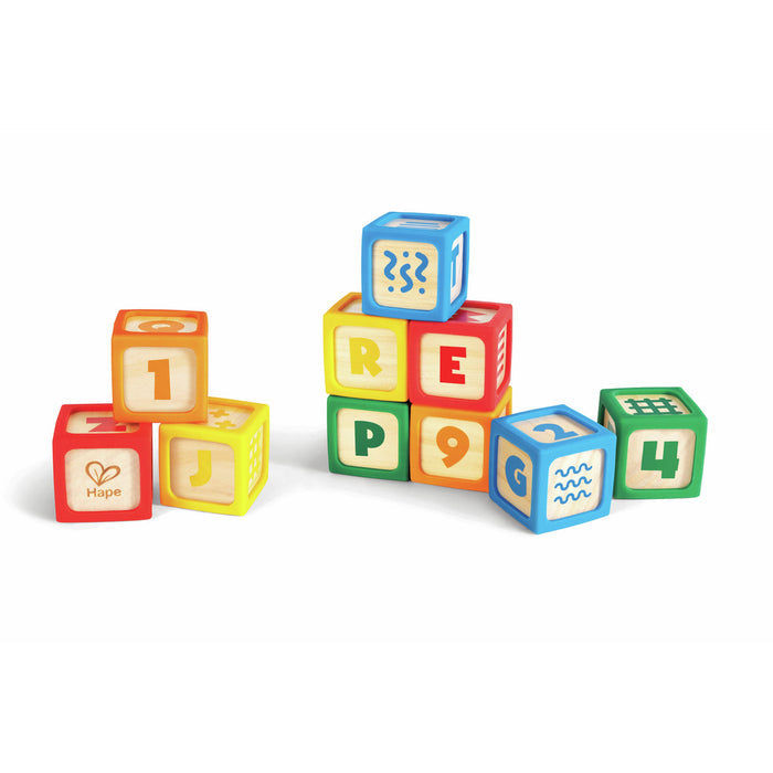 Ten wooden blocks with colorful plastic edges, featuring letters, numbers, and patterns, stacked in small groups.