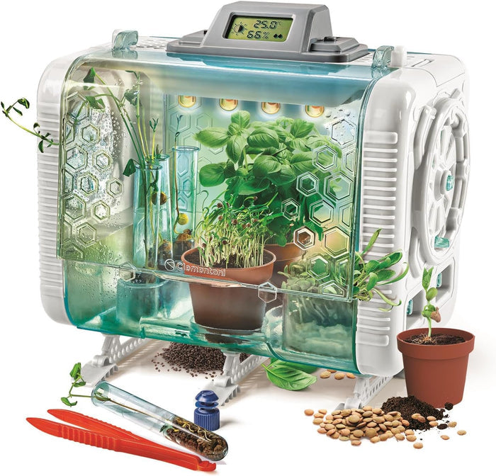 Futuristic white and green toy greenhouse with digital sensor, plants in test tubes, pots, seeds, and red tweezers.
