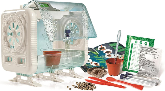 Futuristic white toy greenhouse with clear blue lid, seeds, pots, test tubes, and red tools on a white background.